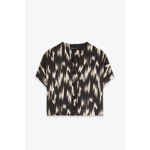 بلوزة عاجية مطبوعة بفتحة رقبة على شكل حرف V