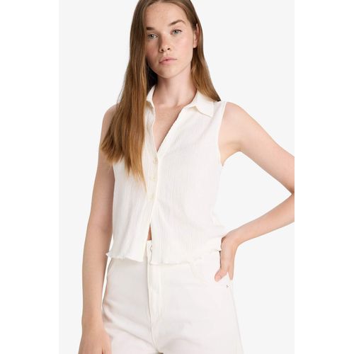 Top slim blanc texturé sans manches à col polo